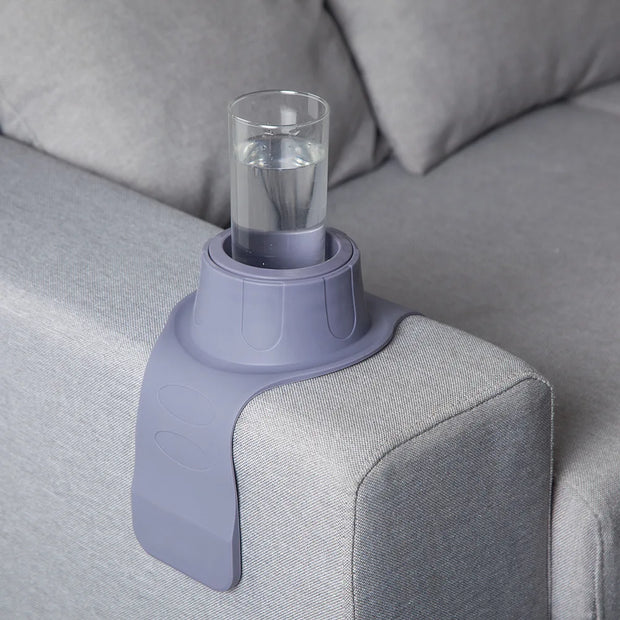 Silicone Cup Holder holding a cup on a reclining sofa armrest